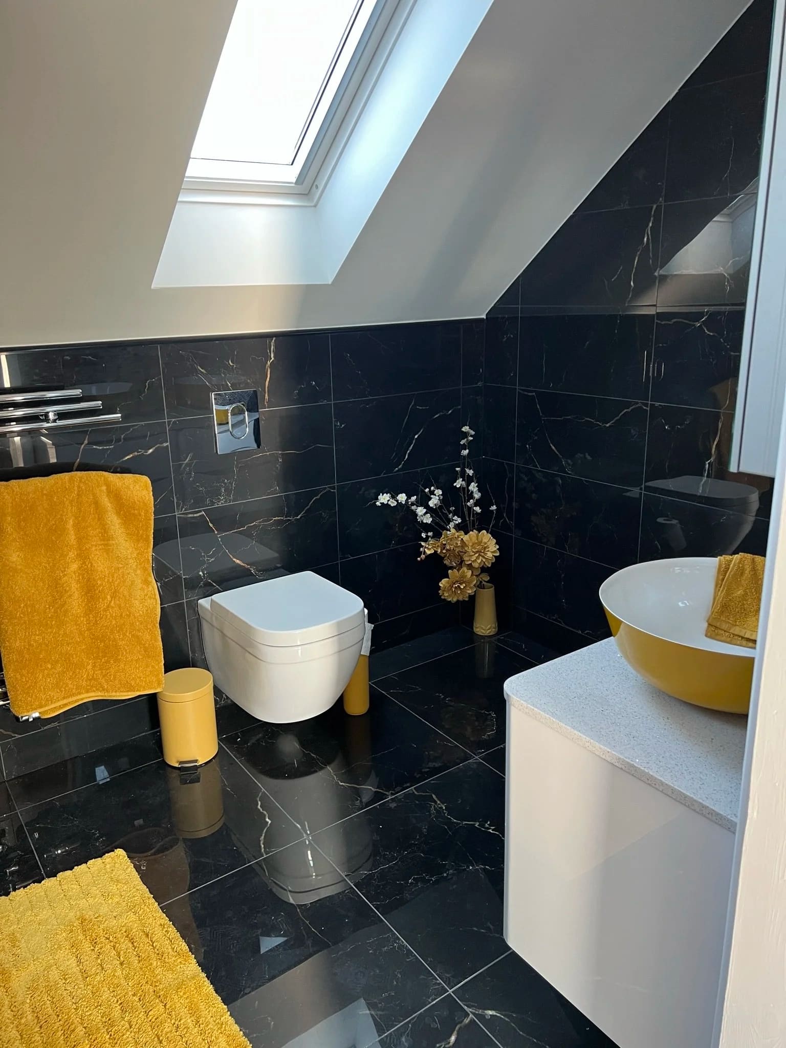 Black marble bathroom with a skylight and mustard basin, fitted by NHF in Grays